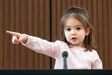 A child confidently introducing themselves